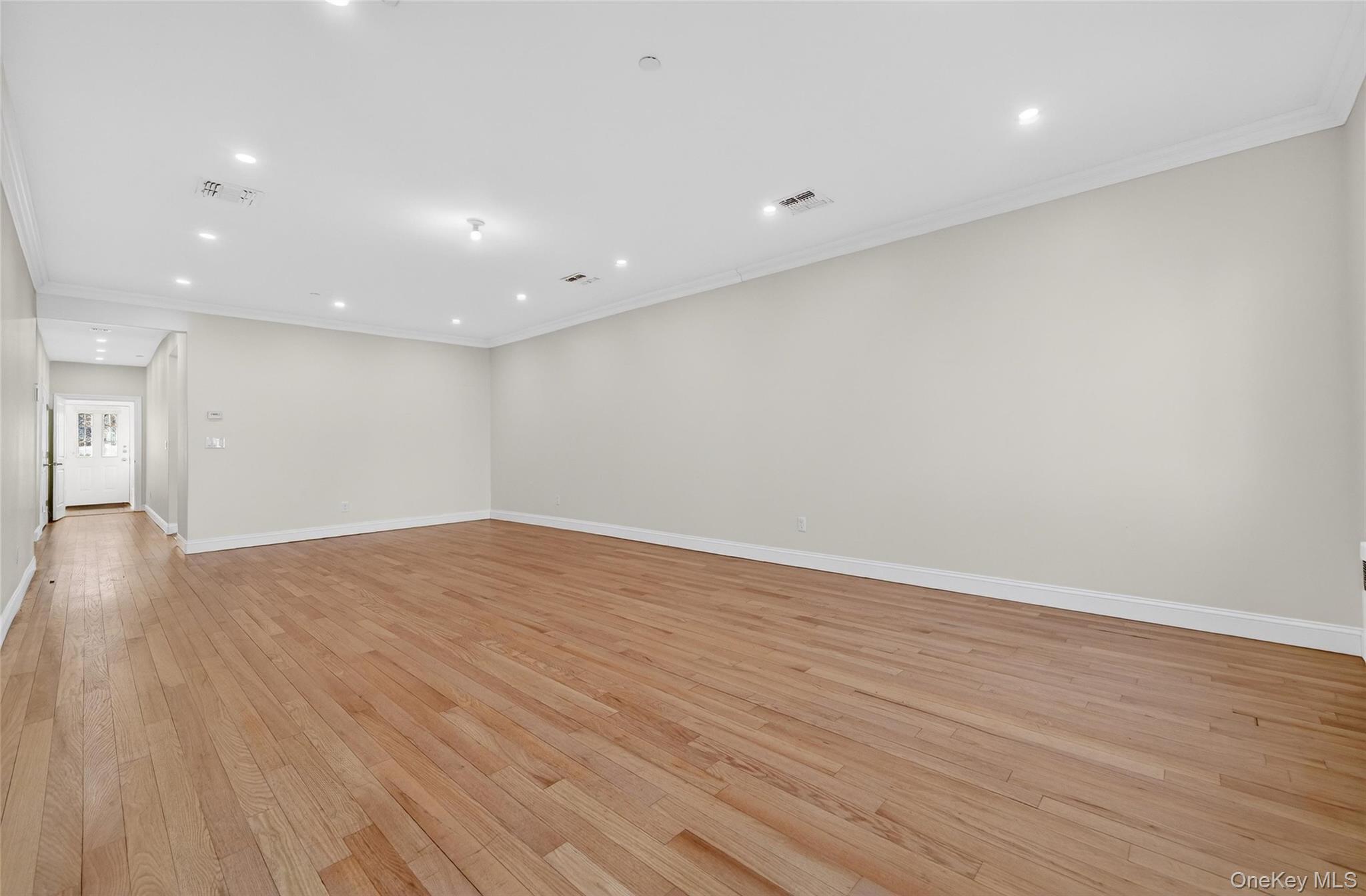 2 Bluefield Drive, Unit 103 Spring Valley, NY 10977 - Photo 21 of 42 Empty room featuring ornamental molding, recessed lighting, and light wood finished floors