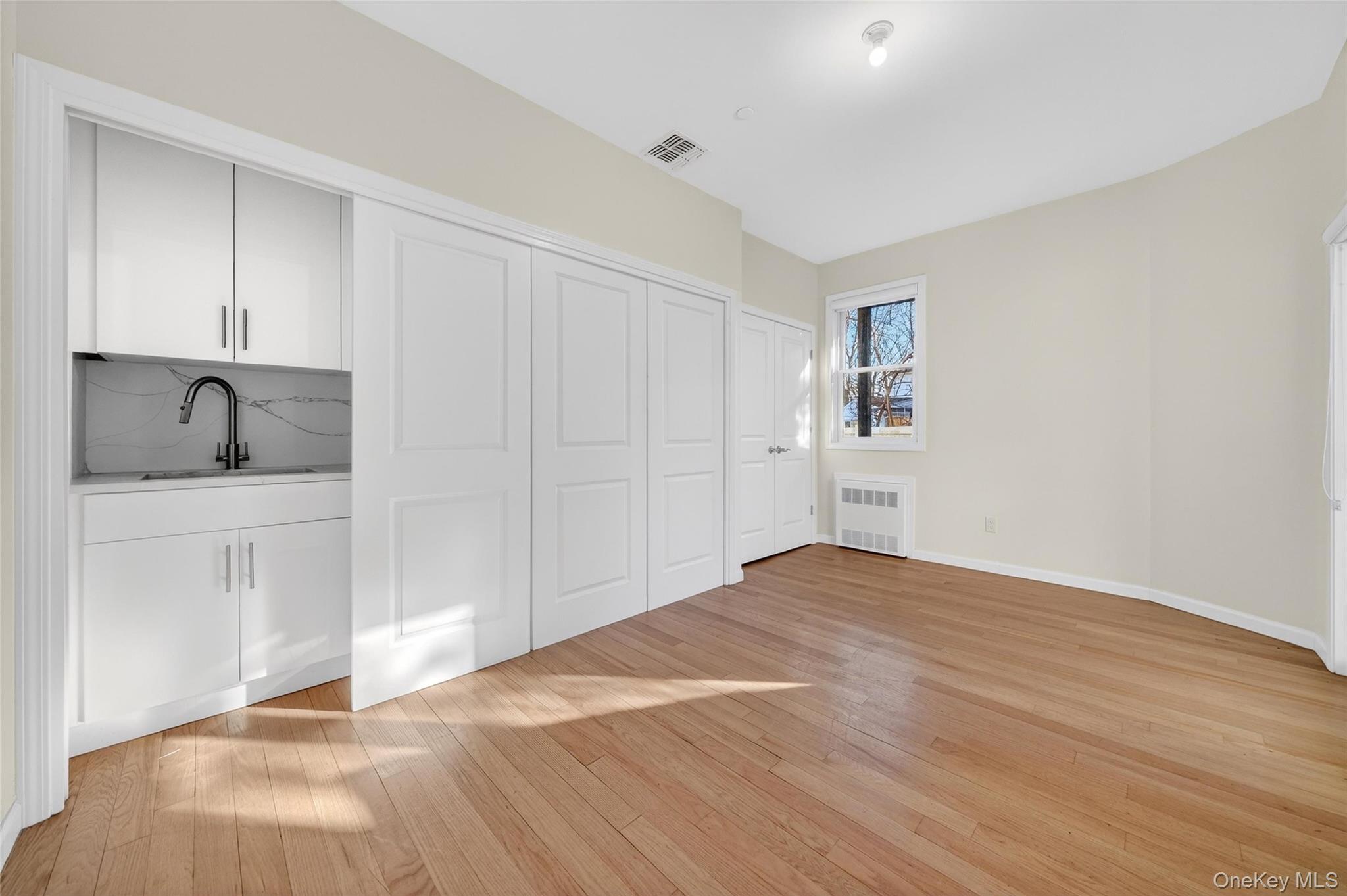 2 Bluefield Drive, Unit 103 Spring Valley, NY 10977 - Photo 25 of 42 a view of empty room with closet and wooden floor