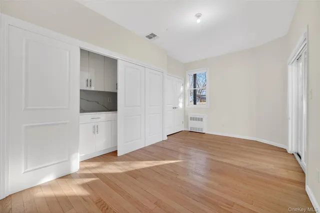 a view of an empty room with glass door