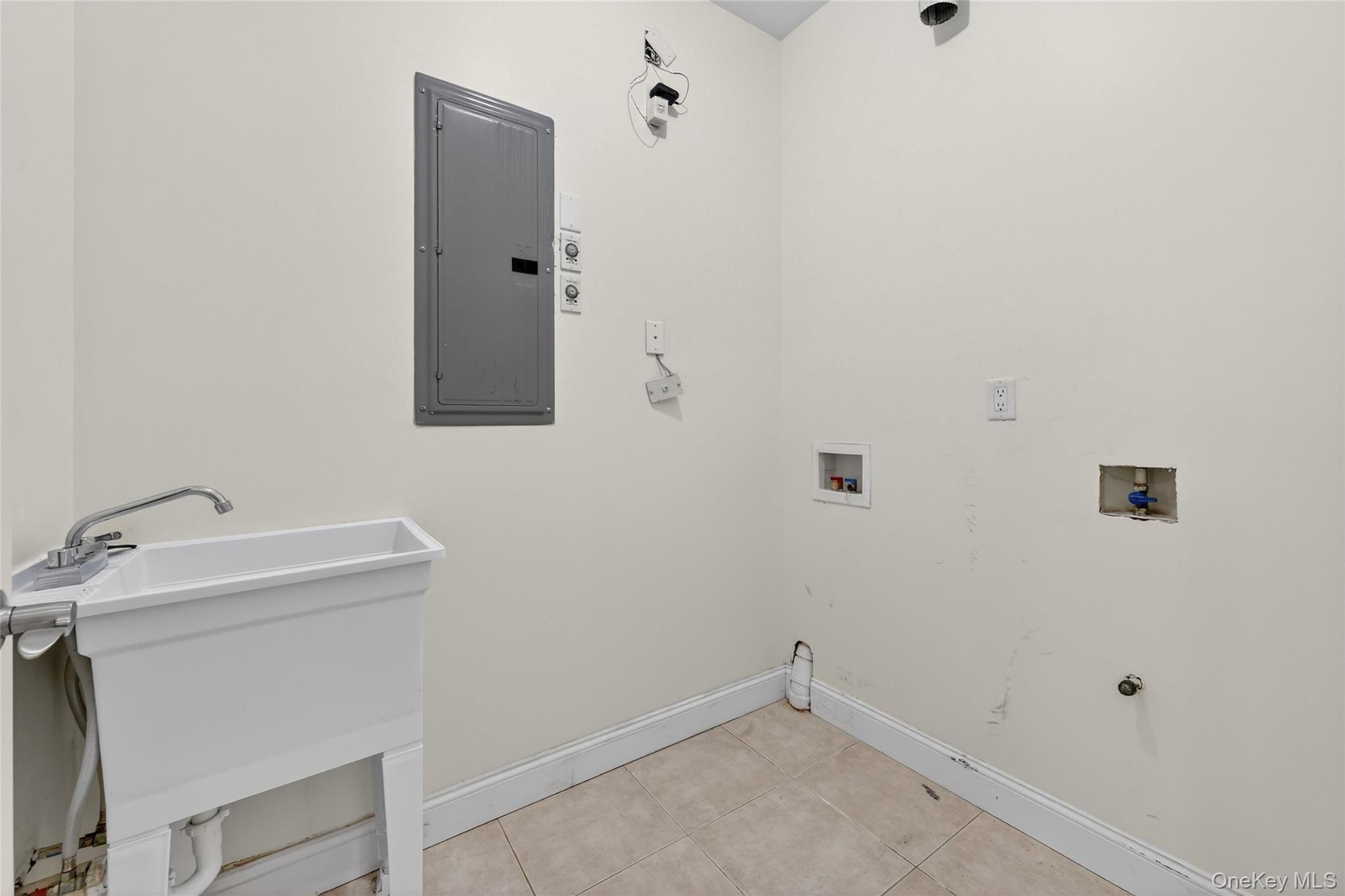 2 Bluefield Drive, Unit 103 Spring Valley, NY 10977 - Photo 27 of 42 Laundry room with washer hookup, electric panel, light tile patterned flooring, and hookup for a gas dryer