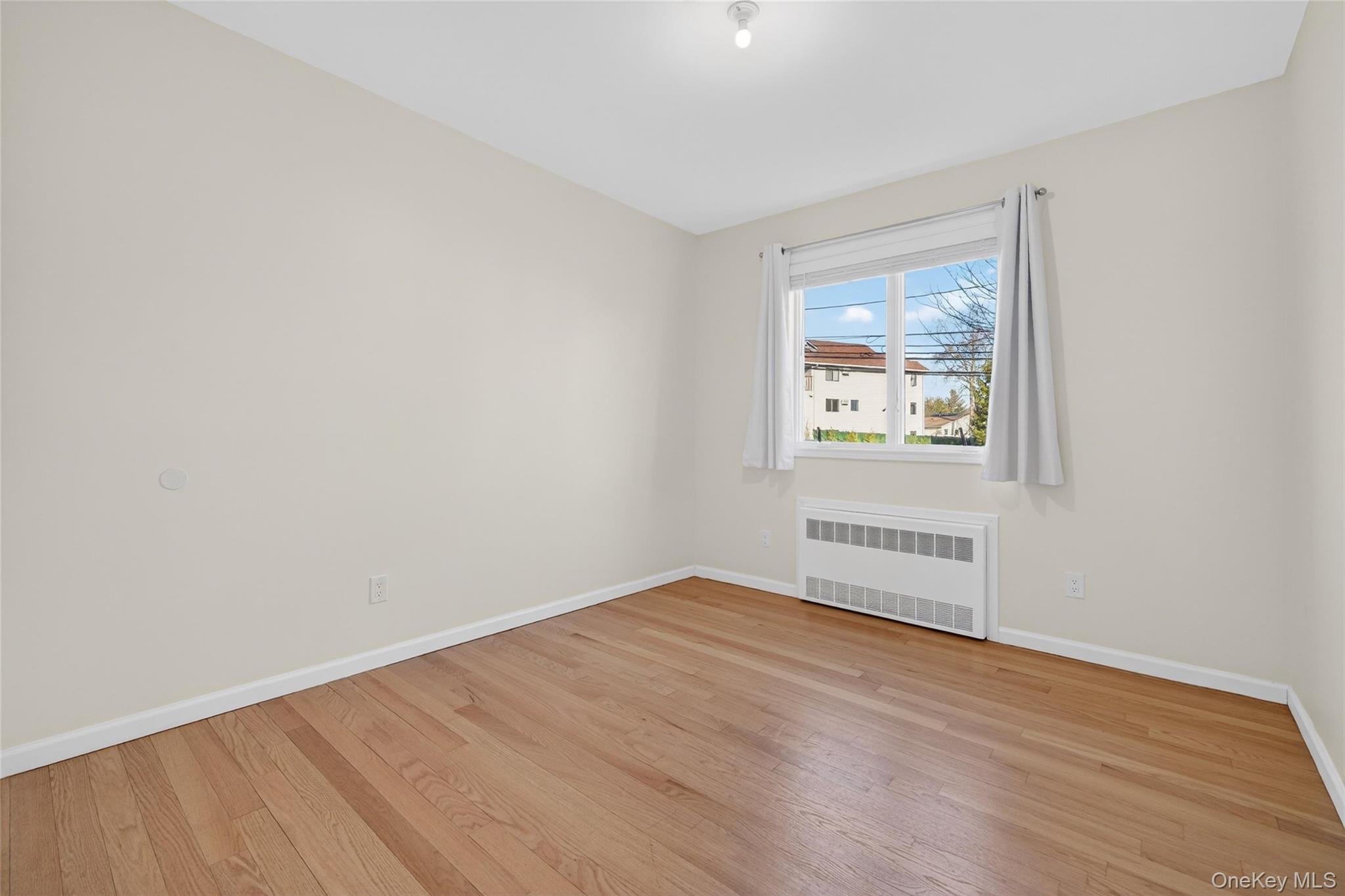 2 Bluefield Drive, Unit 103 Spring Valley, NY 10977 - Photo 29 of 42 an empty room with a window