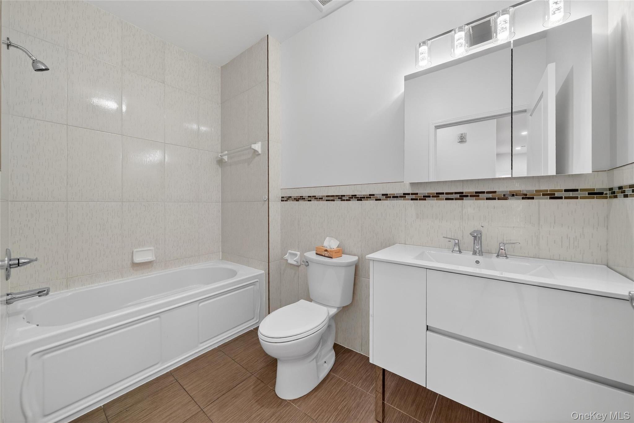 2 Bluefield Drive, Unit 103 Spring Valley, NY 10977 - Photo 30 of 42 a bathroom with a toilet sink a mirror and shower