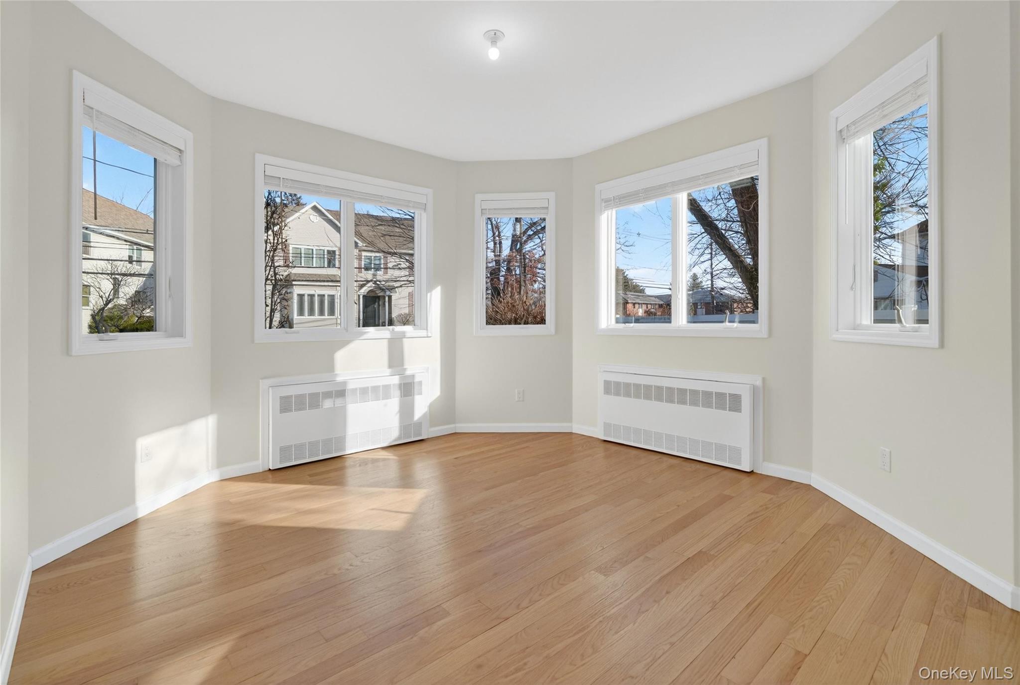 2 Bluefield Drive, Unit 103 Spring Valley, NY 10977 - Photo 32 of 42 a view of an empty room with a window and wooden floor
