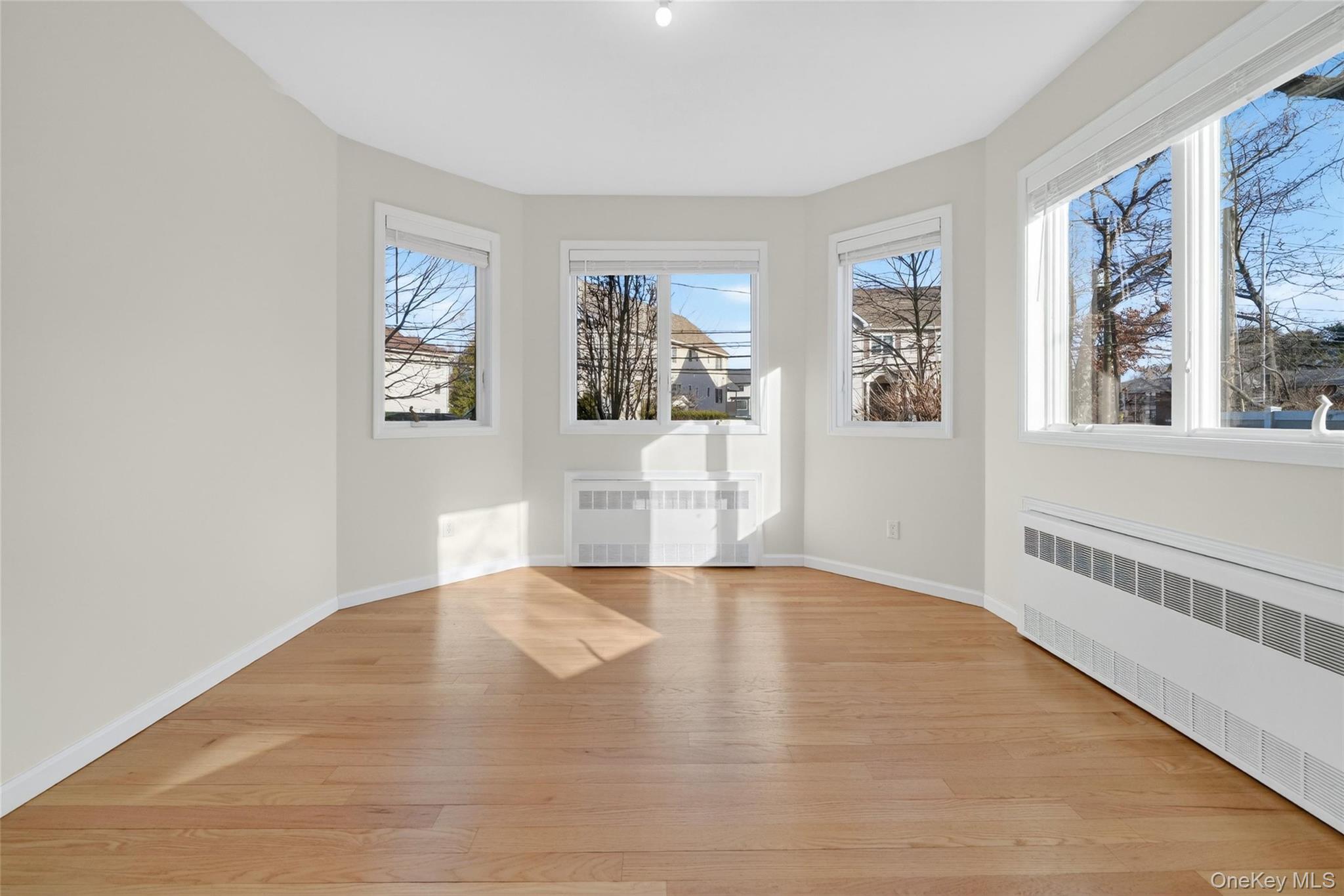 2 Bluefield Drive, Unit 103 Spring Valley, NY 10977 - Photo 33 of 42 a view of an empty room with a window and wooden floor
