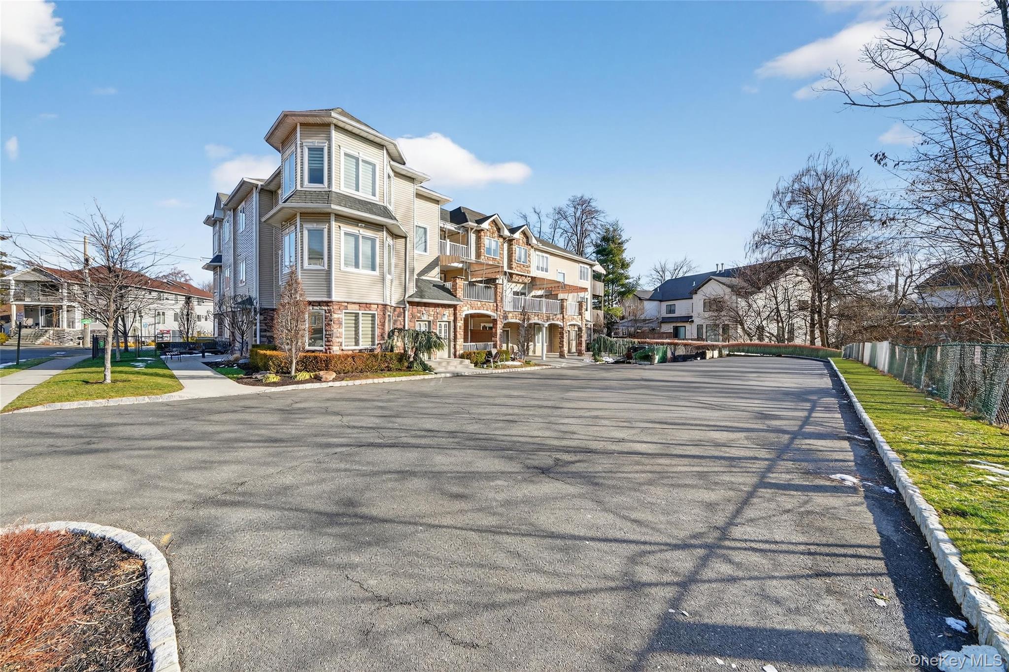 2 Bluefield Drive, Unit 103 Spring Valley, NY 10977 - Photo 42 of 42 View of asphalt street featuring a residential view, curbs, and sidewalks