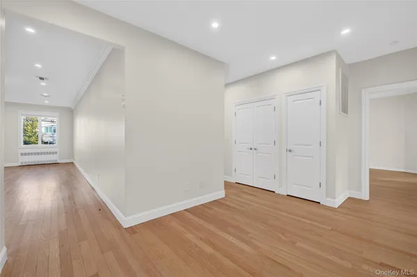 a kitchen with kitchen island white cabinets and stainless steel appliances