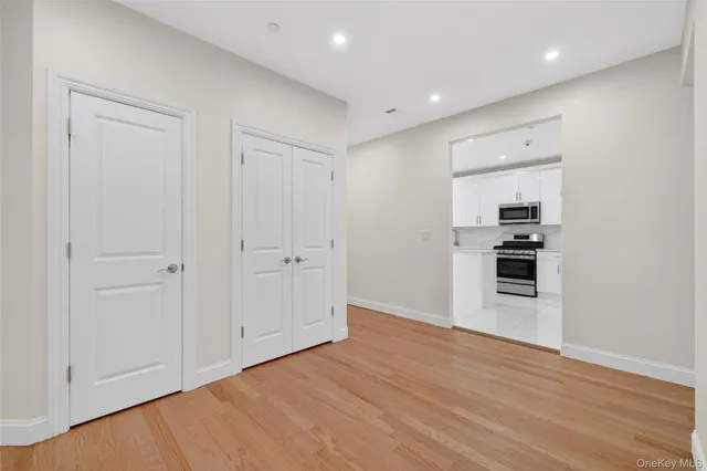 a kitchen with granite countertop white cabinets and stainless steel appliances