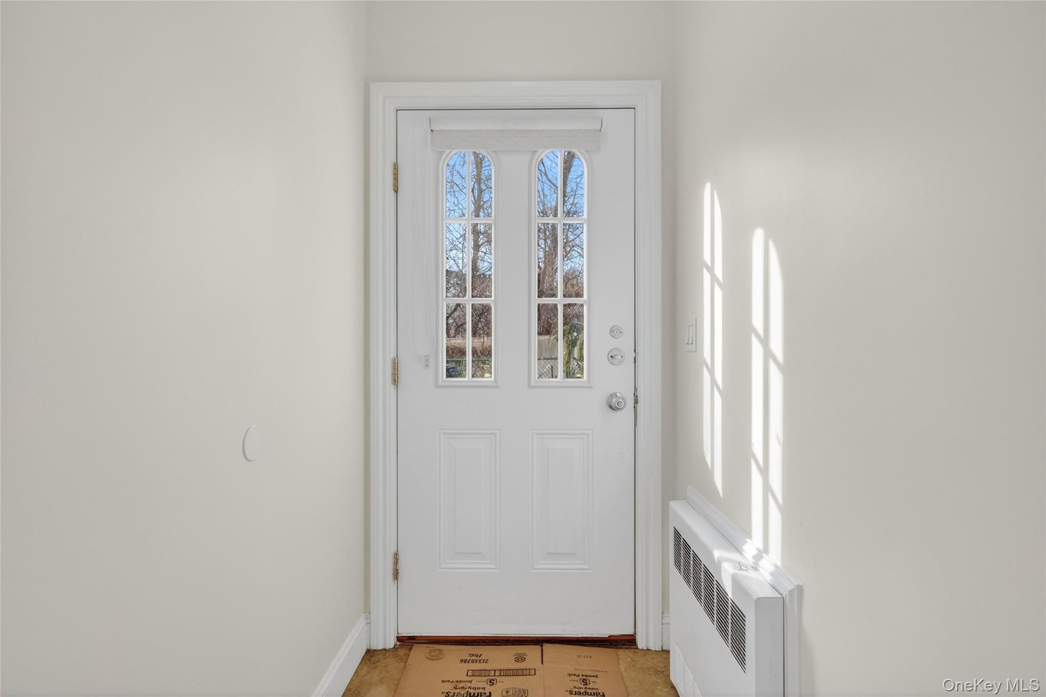 2 Bluefield Drive, Unit 103 Spring Valley, NY 10977 - Photo 9 of 42 Doorway to outside with radiator and baseboards
