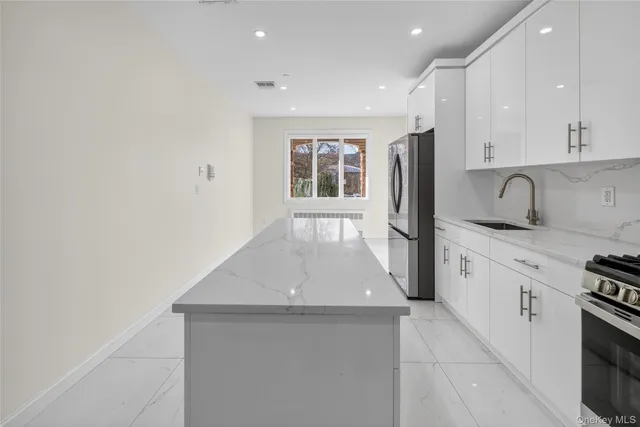 a hallway with a sink and a stove