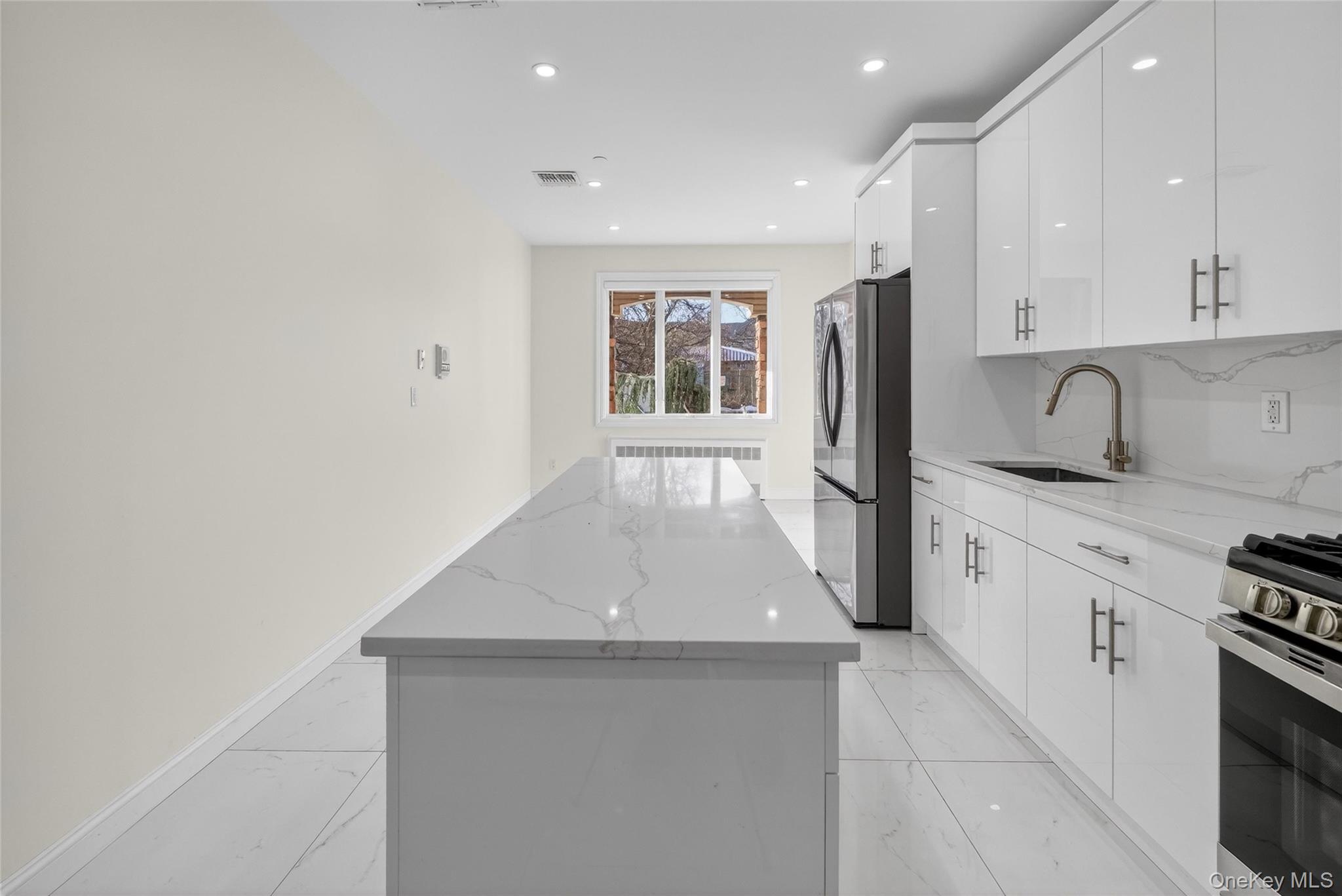 2 Bluefield Drive, Unit 103 Spring Valley, NY 10977 - Photo 10 of 42 a kitchen with stainless steel appliances a refrigerator sink and stove