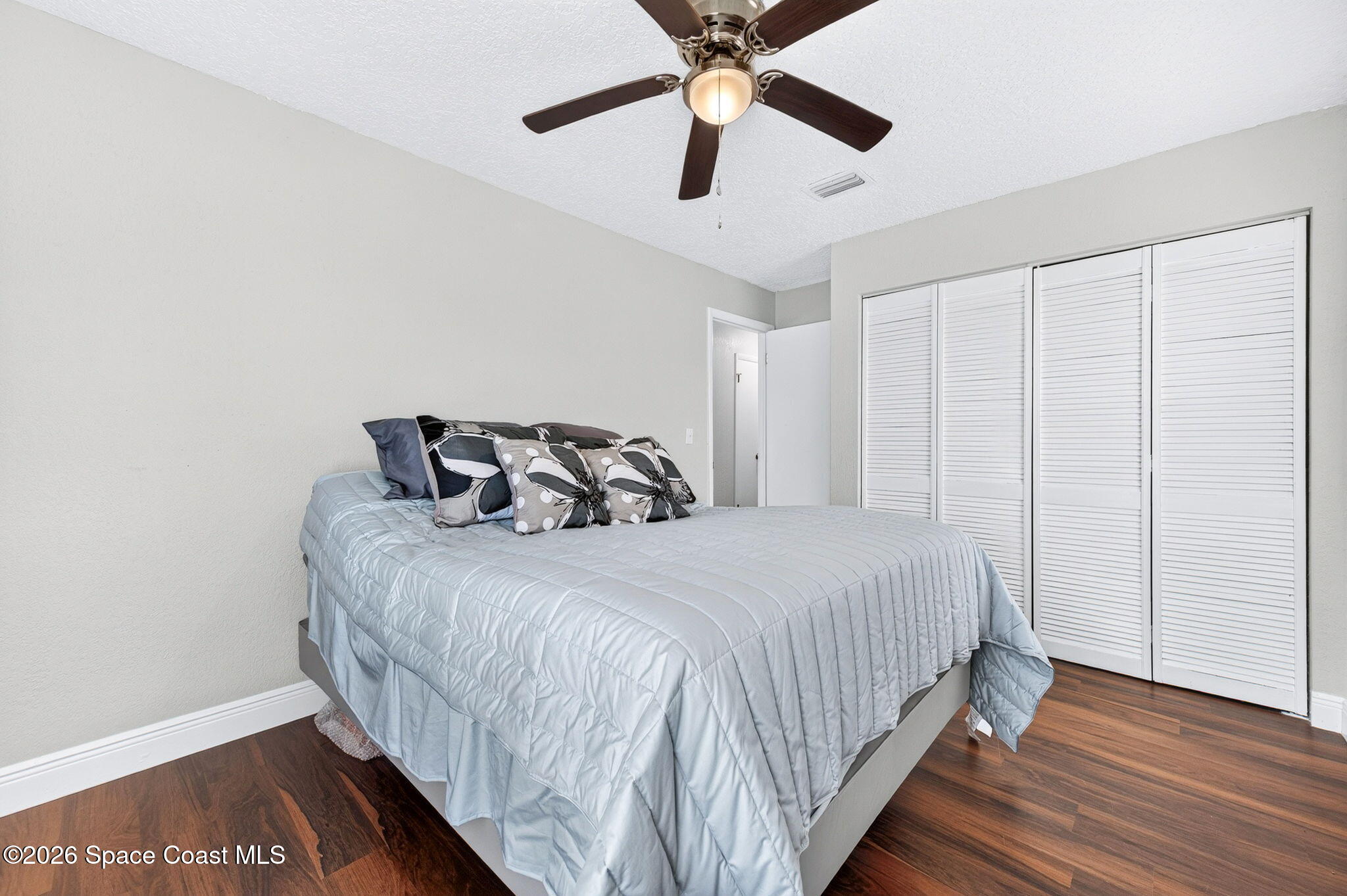 996 Botany Lane Rockledge, FL 32955 - Photo 20 of 35 a bedroom with a bed and wooden floor