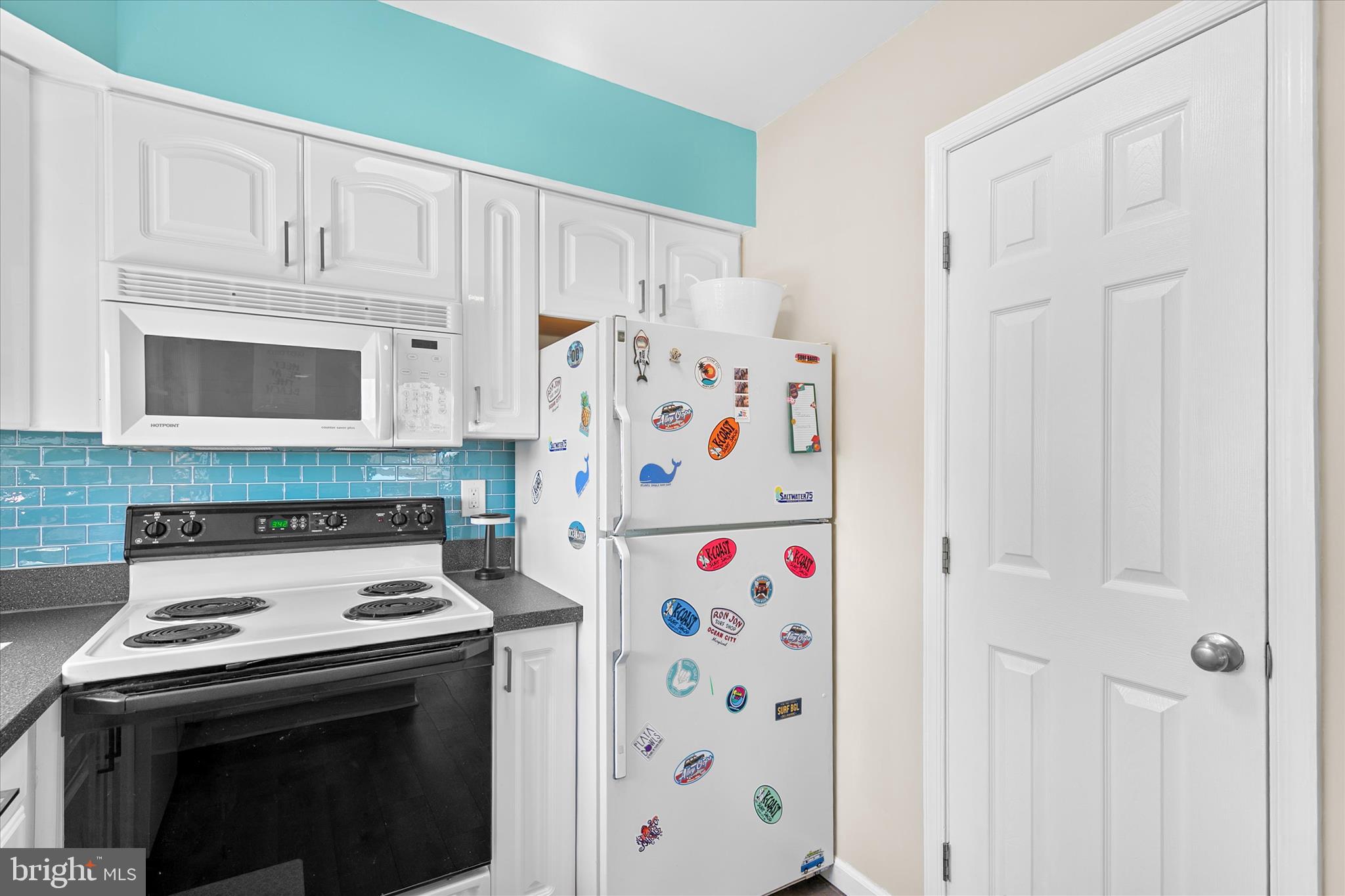 132 Jamestown Road, Unit 601 Ocean City, MD 21842 - Photo 14 of 37 a kitchen with stainless steel appliances white cabinets and a stove