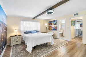 a bedroom with a large bed a desk and chair