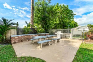 a view of a patio with chairs and potted plants