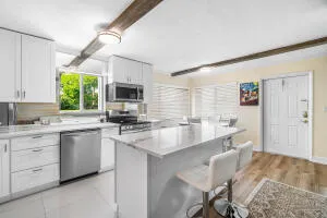 a kitchen with a sink cabinets and window