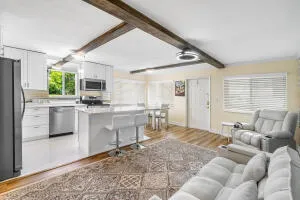 a living room with furniture a window and kitchen view