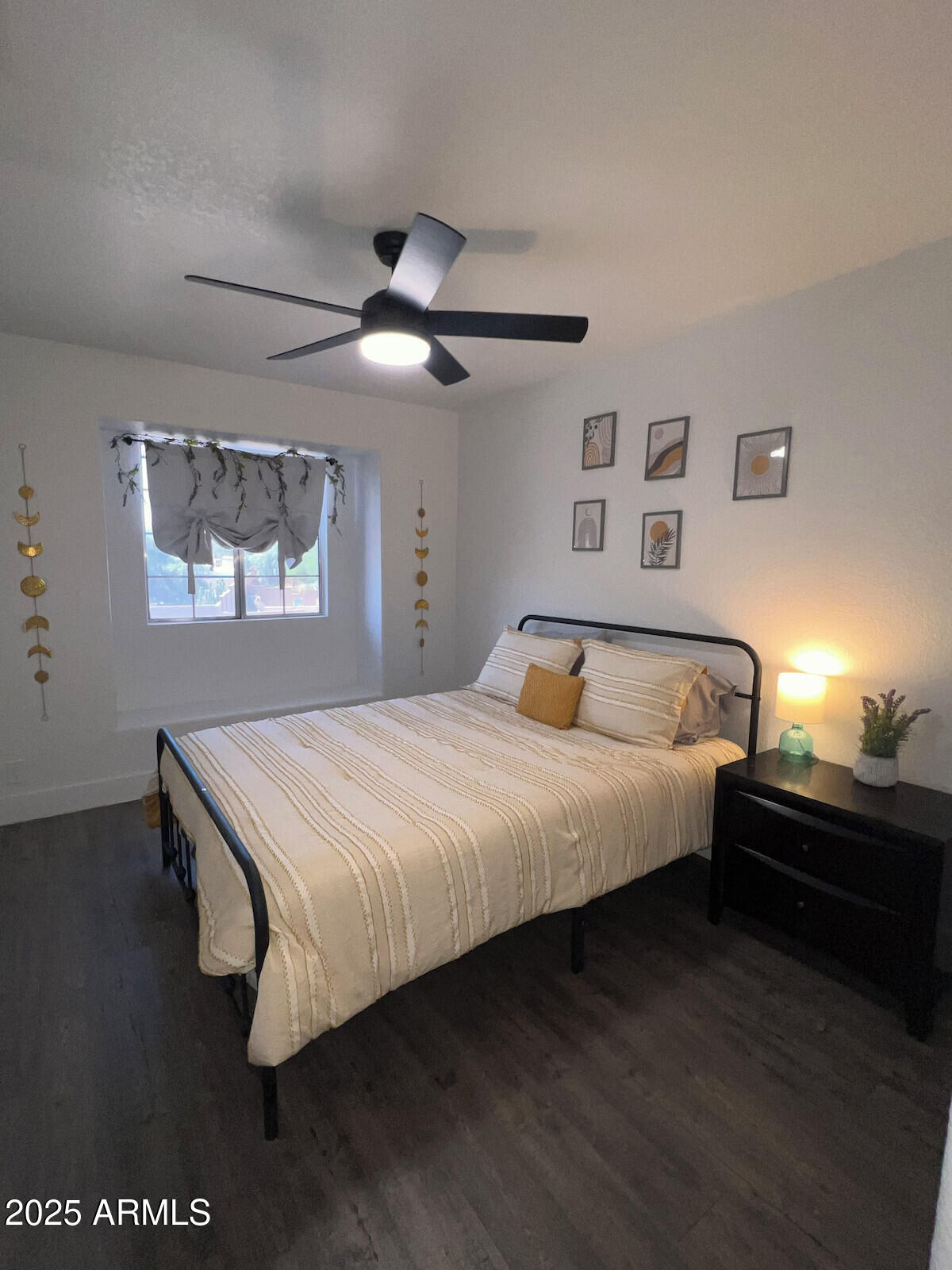 8322 West McLellan Road Glendale, AZ 85305 - Photo 27 of 30 a bedroom with a bed and a chandelier