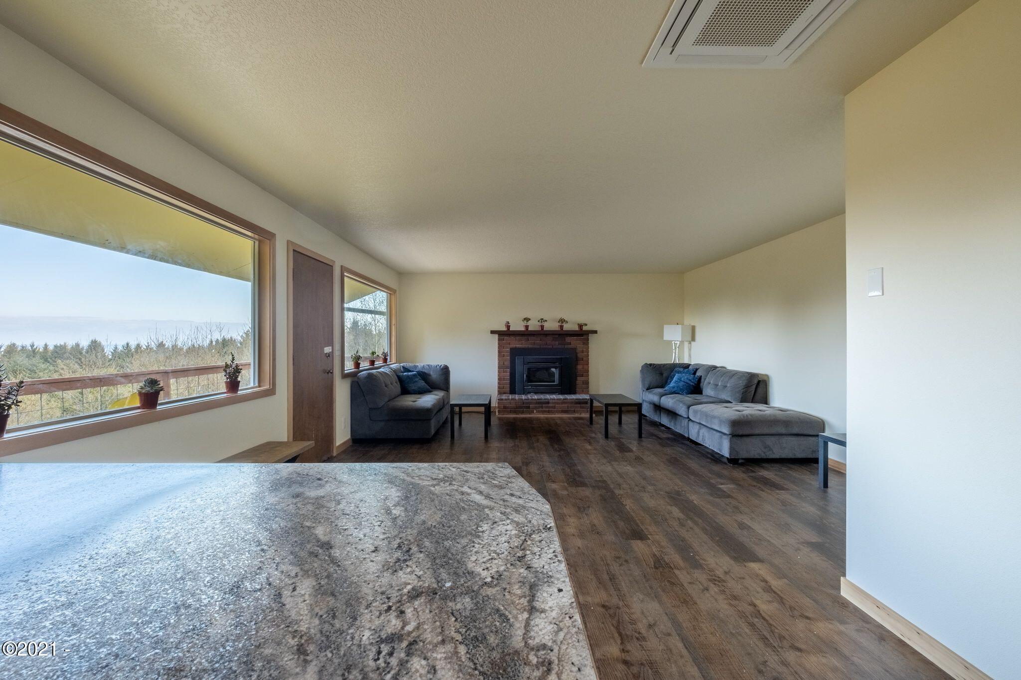 3048 Northeast East Line Road Yachats, OR 97498 - Photo 6 of 31 a living room with furniture and a large window