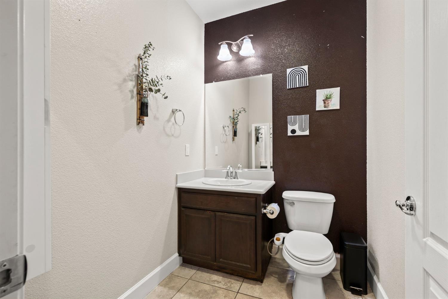 203 Rivage Circle, Unit 203 Folsom, CA 95630 - Photo 13 of 30 a bathroom with a toilet sink and mirror