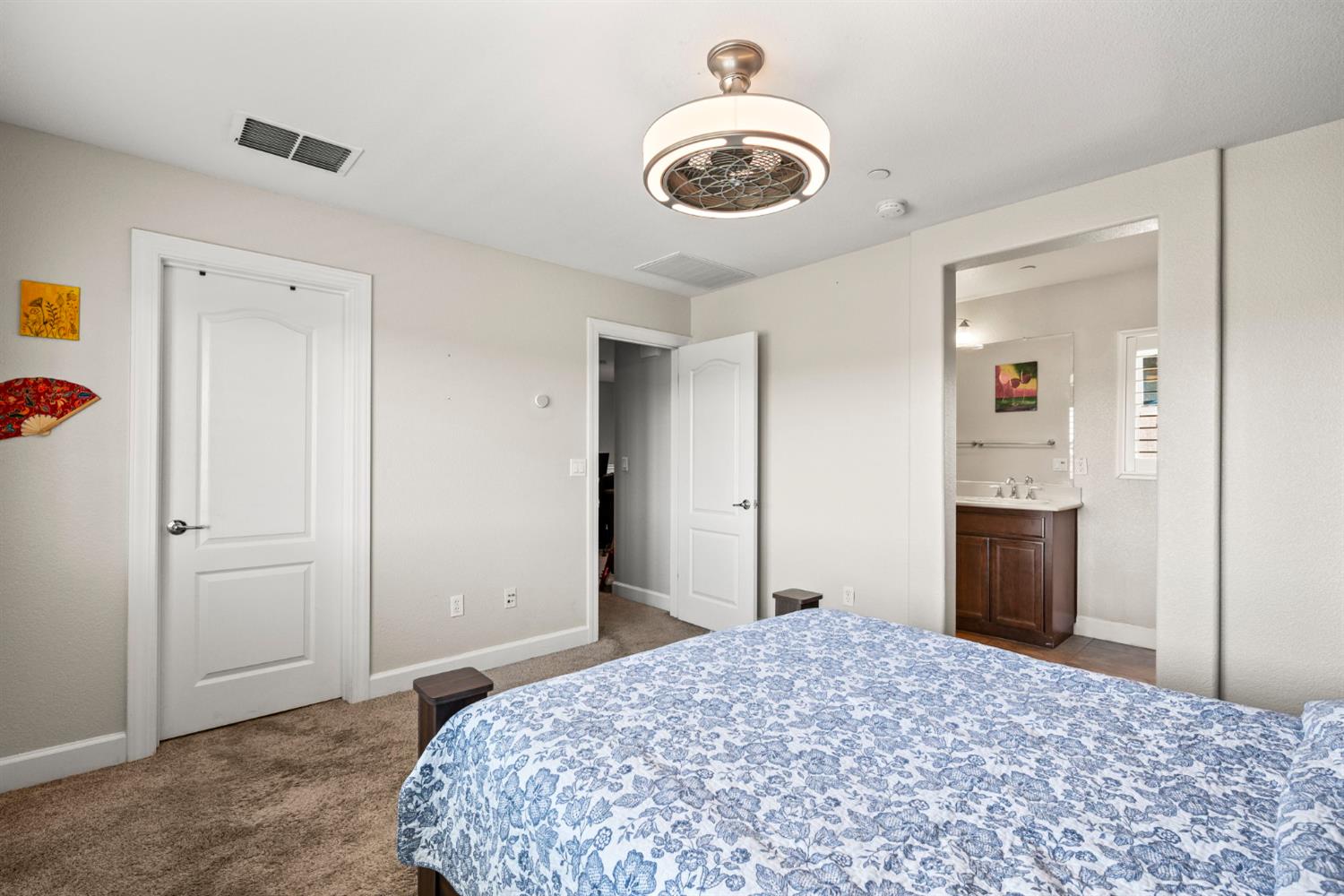 203 Rivage Circle, Unit 203 Folsom, CA 95630 - Photo 19 of 30 a bedroom with a bed and a chandelier