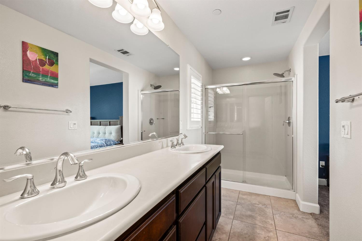 203 Rivage Circle, Unit 203 Folsom, CA 95630 - Photo 21 of 30 a bathroom with a sink a toilet a mirror and shower