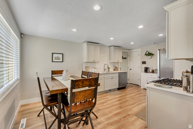 48 Moon Ridge Drive Murray, UT 84107 - Photo 6 of 30 Kitchen and dining area featuring wood-finish flooring