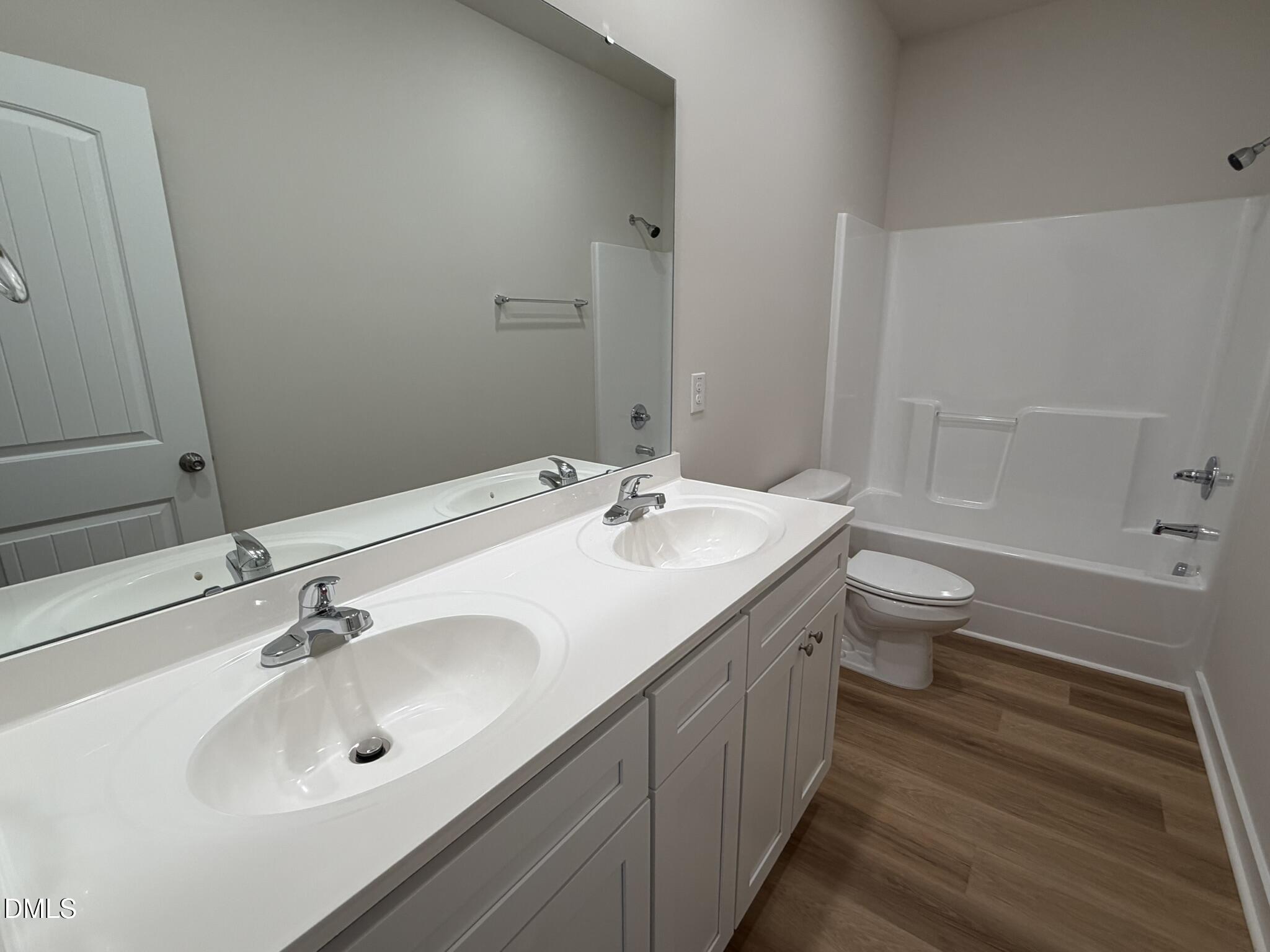 219 Jacobs Ridge Drive Four Oaks, NC 27524 - Photo 12 of 19 a bathroom with a double vanity sink toilet and a mirror