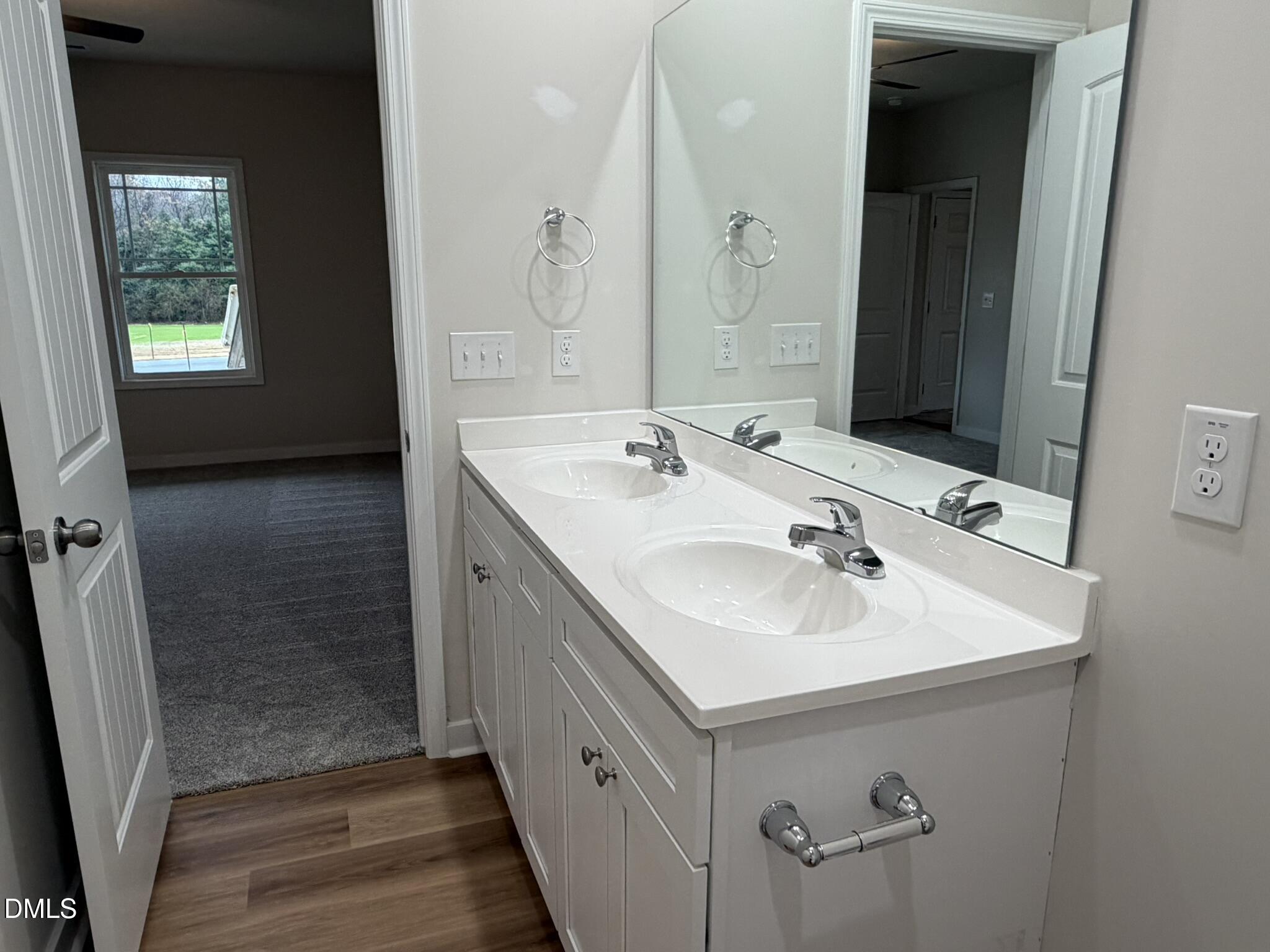 219 Jacobs Ridge Drive Four Oaks, NC 27524 - Photo 13 of 19 a bathroom with a sink a mirror and a shower