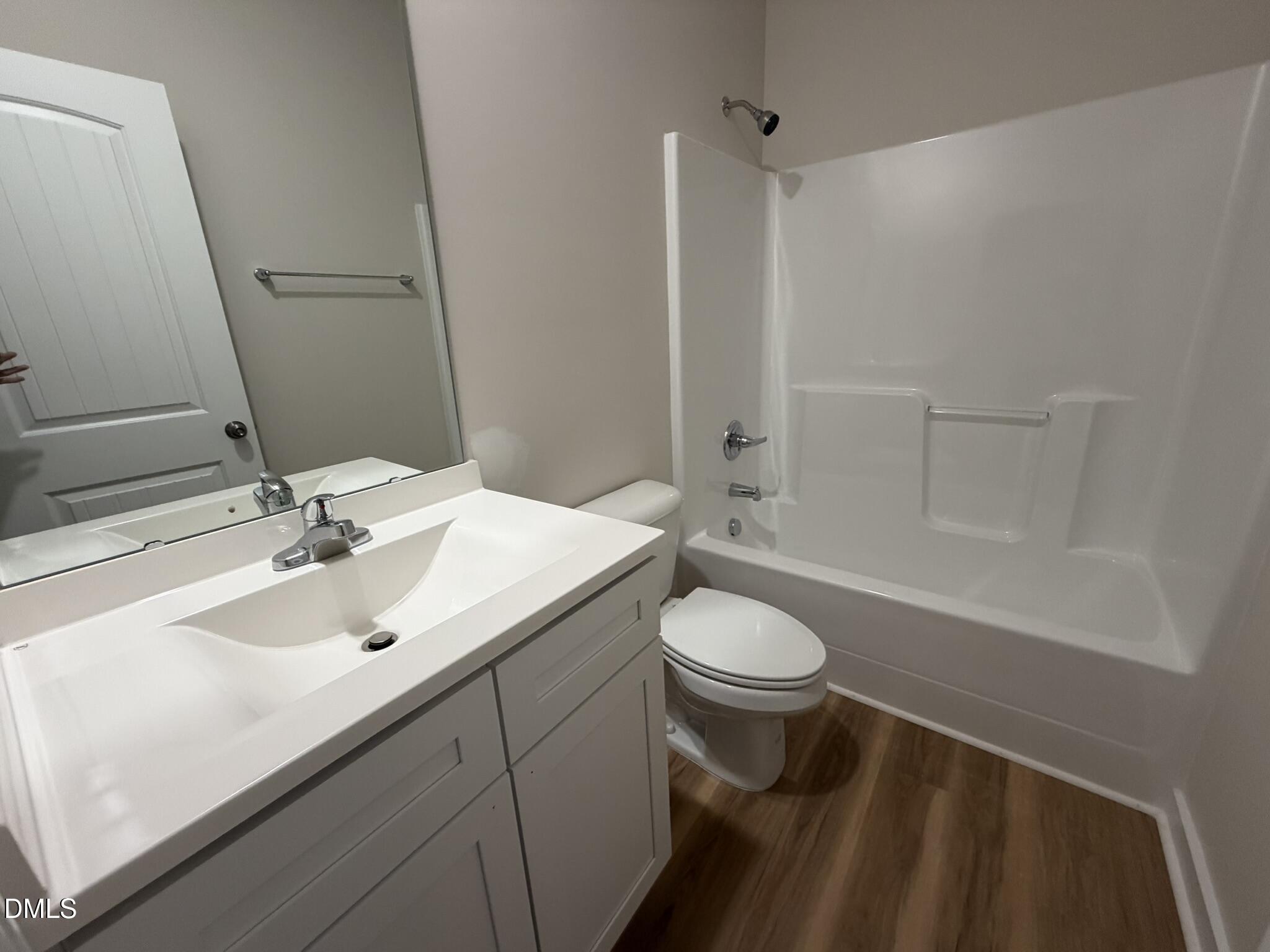 219 Jacobs Ridge Drive Four Oaks, NC 27524 - Photo 16 of 19 a bathroom with a sink a toilet and shower
