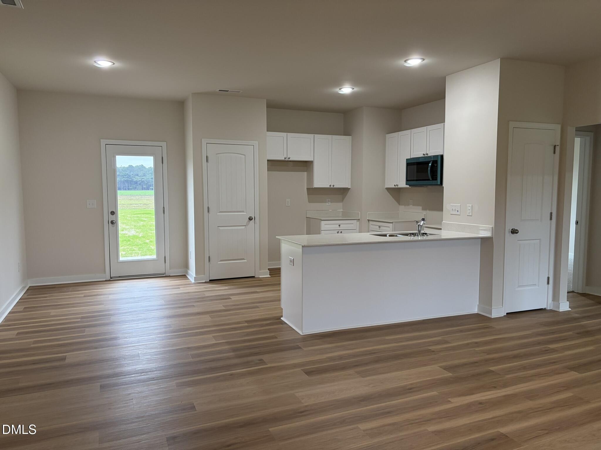 219 Jacobs Ridge Drive Four Oaks, NC 27524 - Photo 2 of 19 a view of kitchen with wooden floor and window