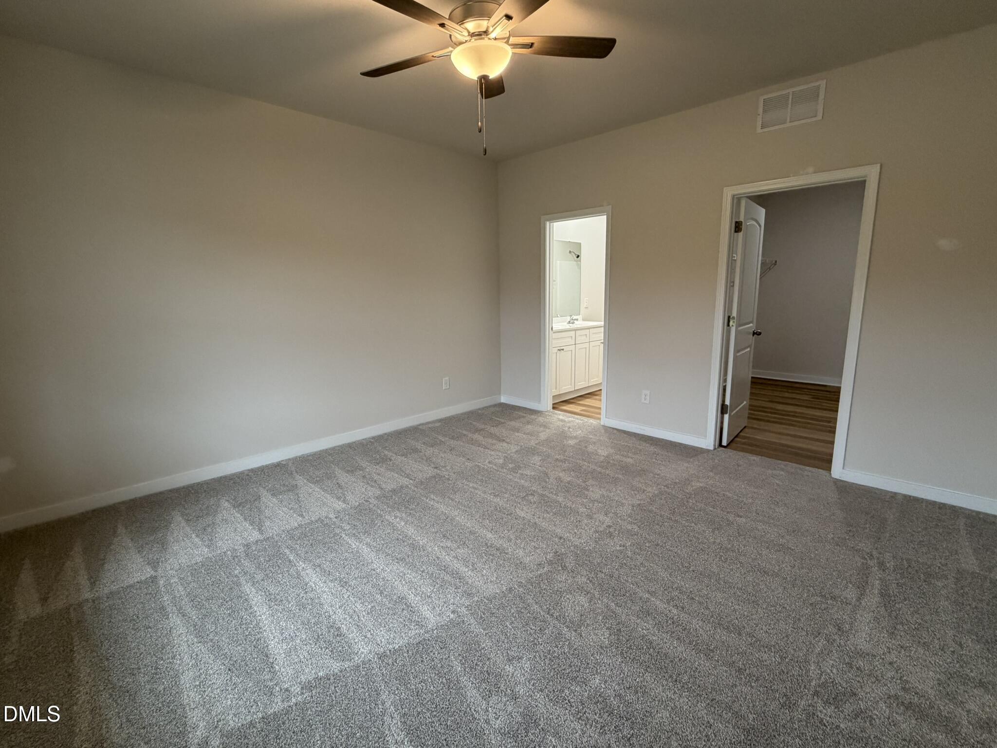 219 Jacobs Ridge Drive Four Oaks, NC 27524 - Photo 9 of 19 a view of an empty room with a ceiling fan