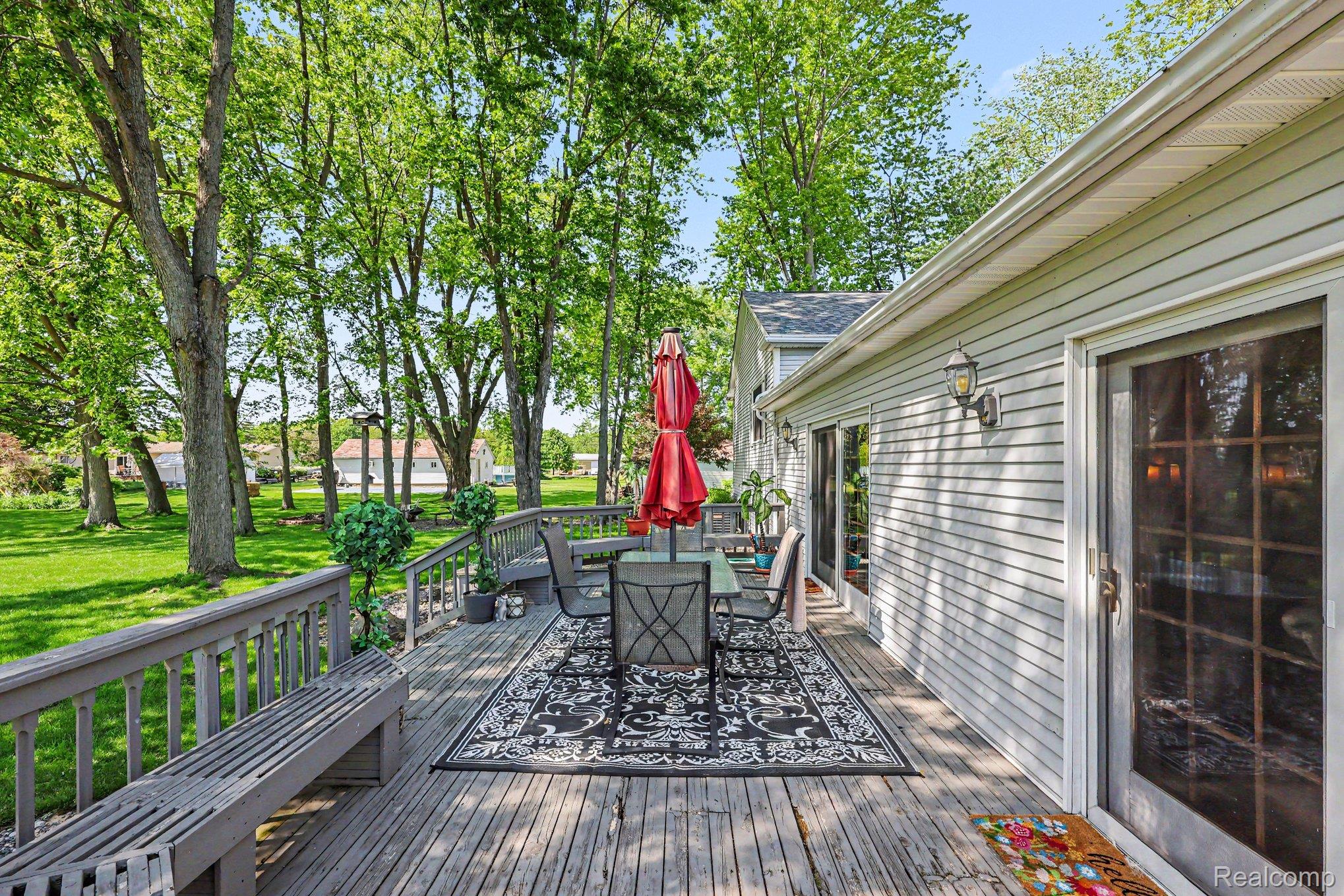 7020 Meldrum Road Fair Haven, MI 48023 - Photo 27 of 43 Spacious outdoor deck featuring natural wood decking and an integrated bench seating area