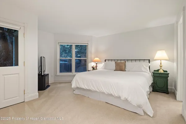 a spacious bedroom with a bed and window