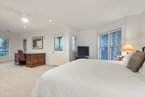 a bedroom with bed and a window