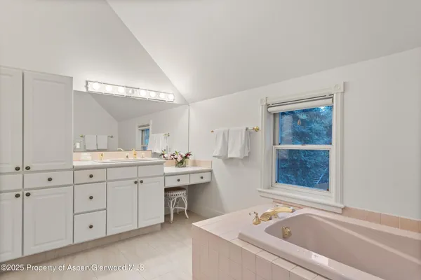 a bathroom with a double vanity sink mirror and toilet