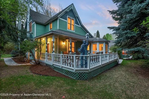 a view of a house with a yard and deck