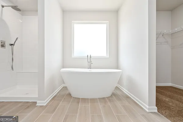 a white bath tub sitting in a bathroom