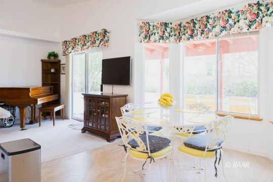 1248 Arroyo Street Ridgecrest, CA 93555 - Photo 14 of 34 a living room with furniture a flat screen tv and a floor to ceiling window