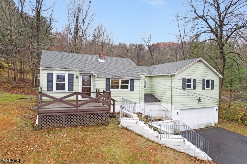 a front view of a house with a yard and outdoor seating