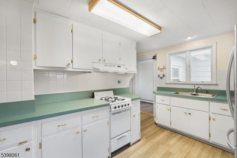 34 Old Mountain Road Lebanon, NJ 08833 - Photo 12 of 26 a kitchen with granite countertop a sink a stove and cabinets