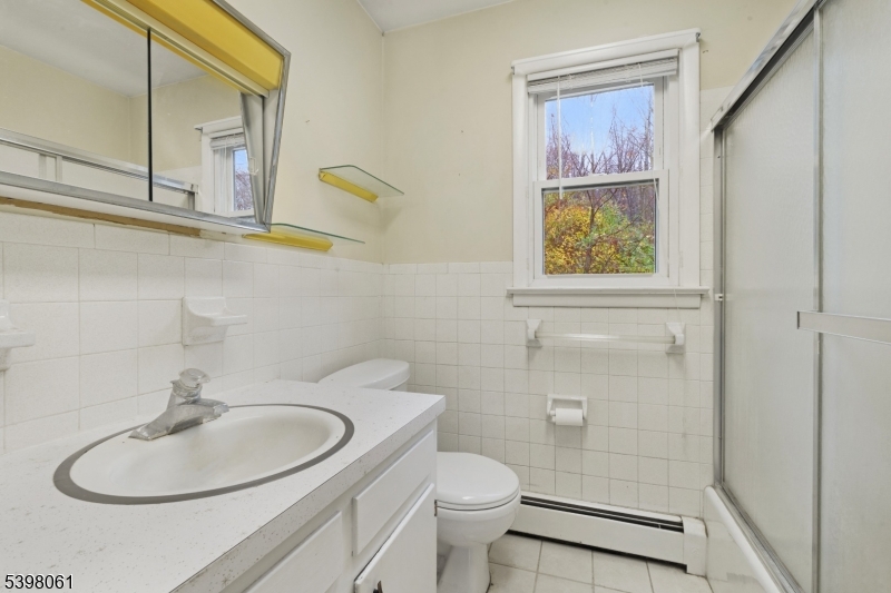 34 Old Mountain Road Lebanon, NJ 08833 - Photo 18 of 26 a bathroom with a toilet sink and mirror