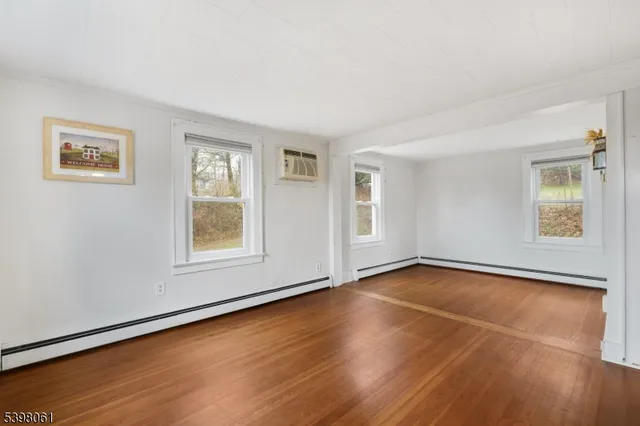 a view of a room with wooden floor and window