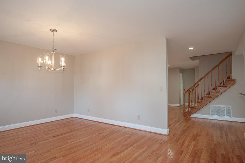 6525 Joyce Road Alexandria, VA 22310 - Photo 11 of 51 a view of empty room with wooden floor and chandelier