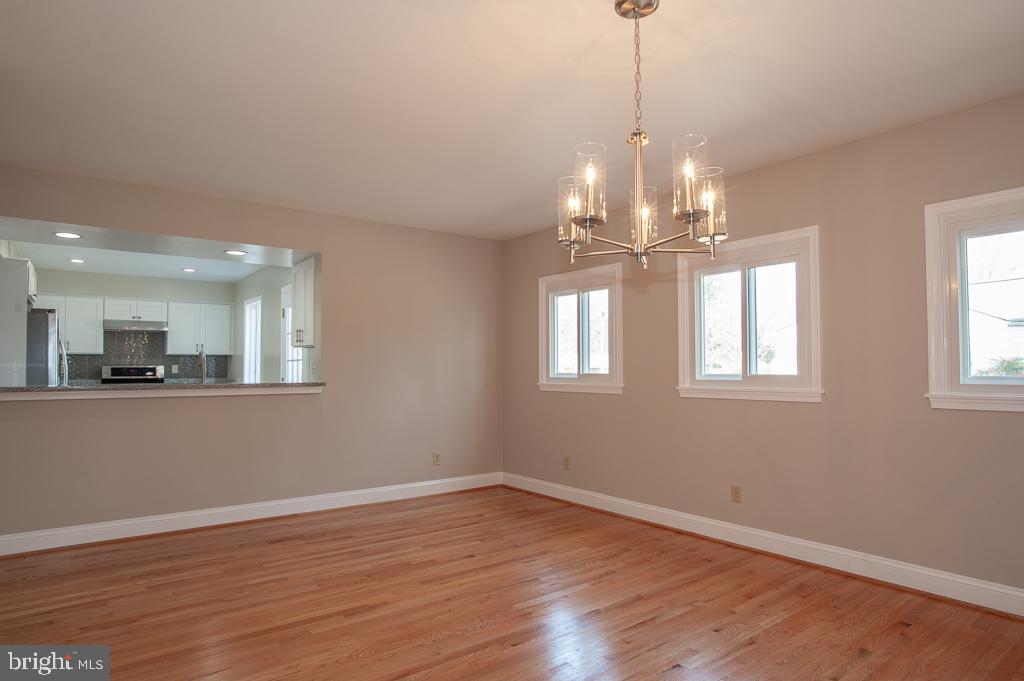 6525 Joyce Road Alexandria, VA 22310 - Photo 12 of 51 a view of a room with wooden floor chandelier and windows