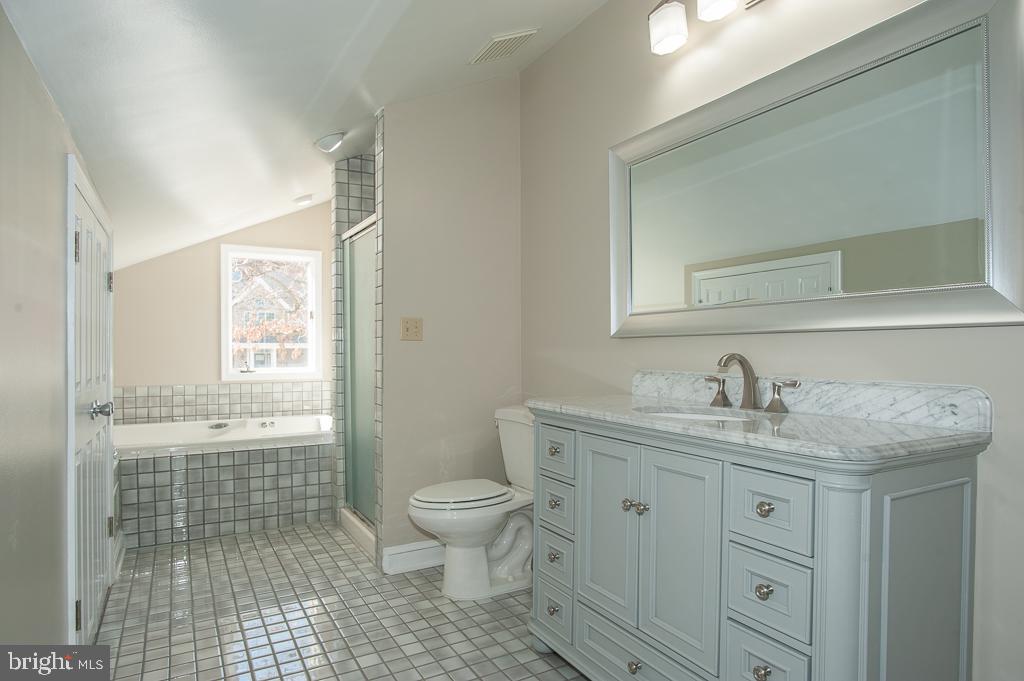 6525 Joyce Road Alexandria, VA 22310 - Photo 23 of 51 a bathroom with a granite countertop sink a toilet and a shower