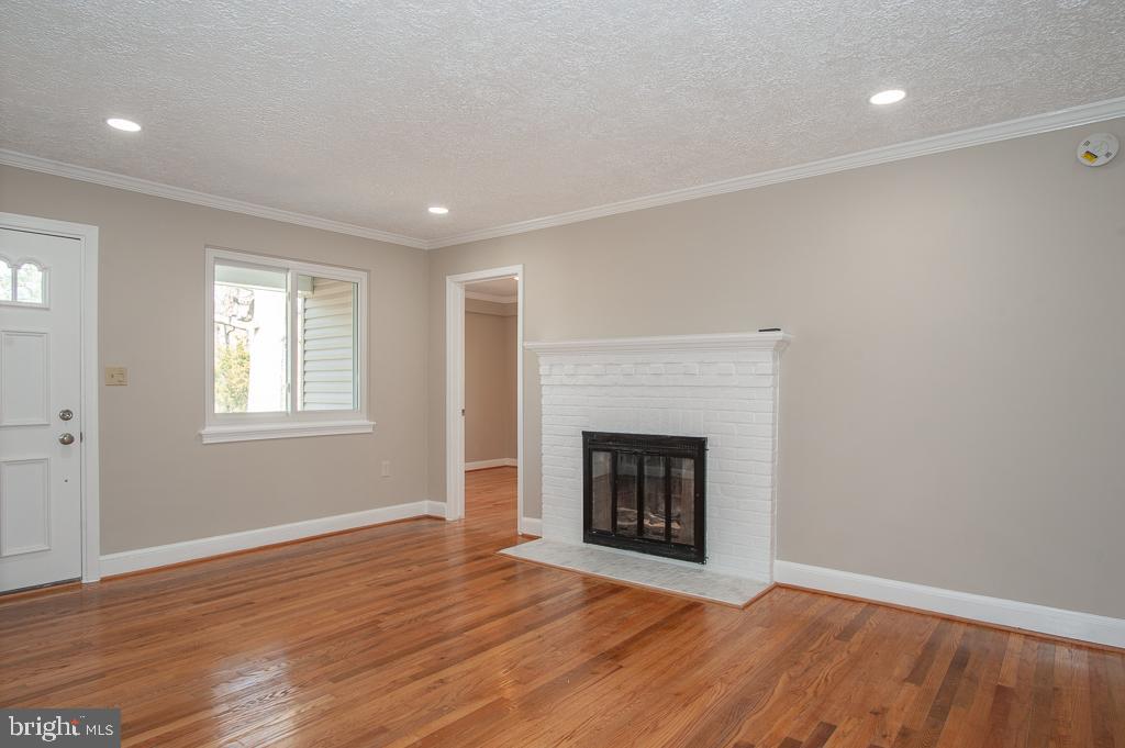6525 Joyce Road Alexandria, VA 22310 - Photo 4 of 51 a view of an empty room with wooden floor fireplace and a window