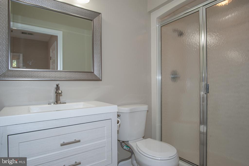 6525 Joyce Road Alexandria, VA 22310 - Photo 35 of 51 a bathroom with a sink toilet vanity and mirror