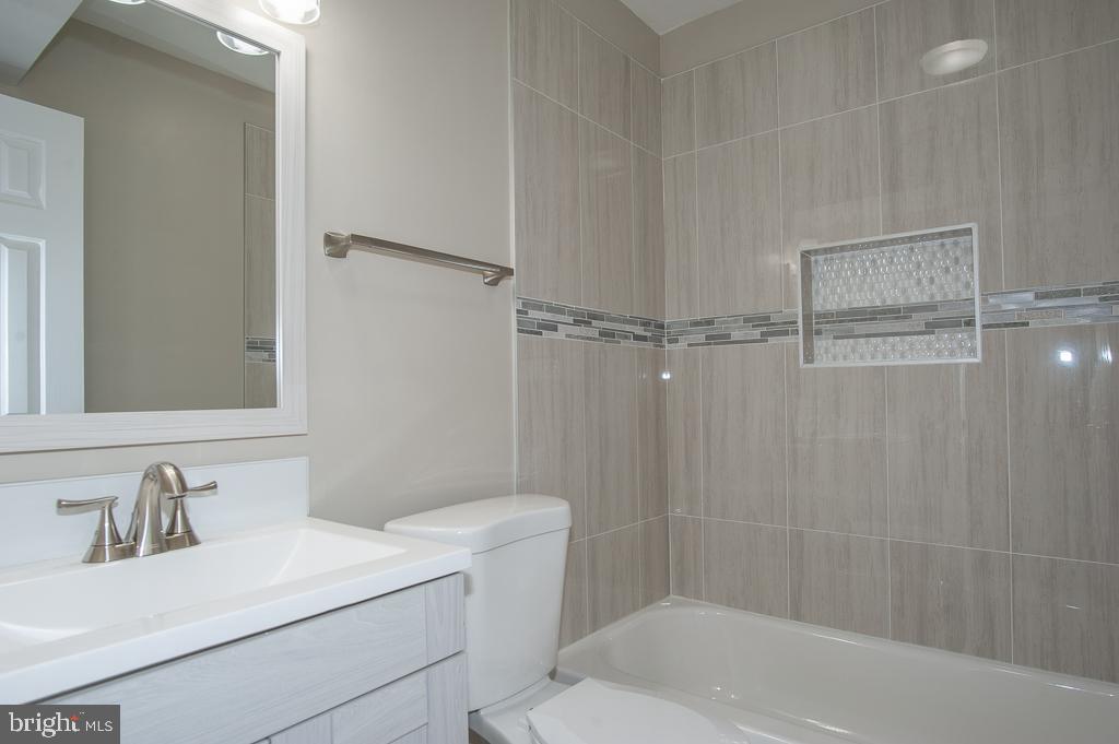 6525 Joyce Road Alexandria, VA 22310 - Photo 38 of 51 a bathroom with a sink toilet vanity and shower