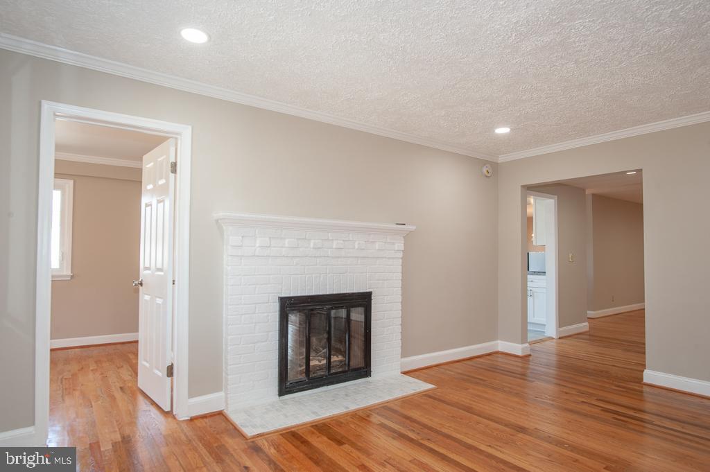 6525 Joyce Road Alexandria, VA 22310 - Photo 5 of 51 a view of a livingroom with wooden floor and a fireplace