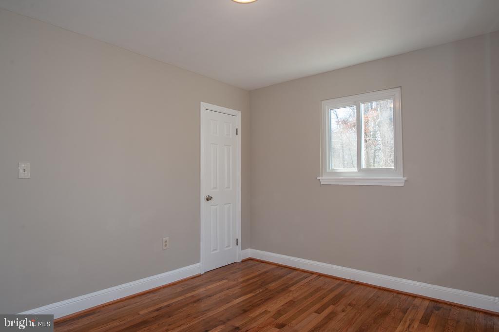 6525 Joyce Road Alexandria, VA 22310 - Photo 42 of 51 a view of an empty room with wooden floor and a window